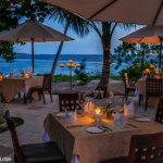 wakatobi resort has a inside/outside dining areas that offer nice views of the beach and sea - coral triangle adventures