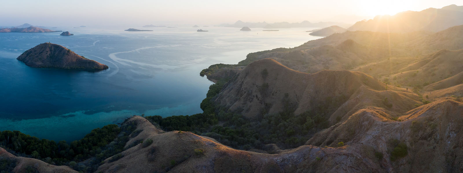 Sunset over Komodo national Park photographed while on a coral triangle adventures snorkeling tour