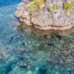 Snorkelers enjoying a reef on coral triangle adventures snorkeling tour to Raja Ampat